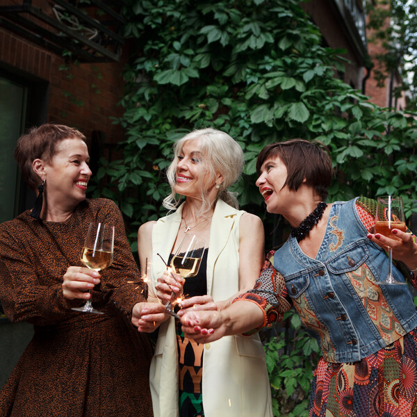 Mature women celebrate with champagne