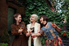 Mature women celebrate with champagne