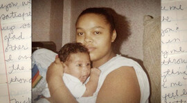 A screenshot of a Black woman and baby in front of a written note from the film