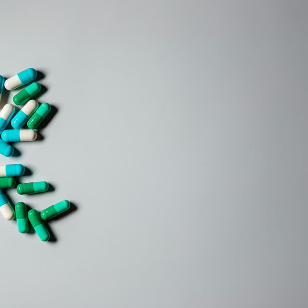 A white background with pills to the left