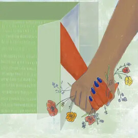 Two hands clasped together with flowers