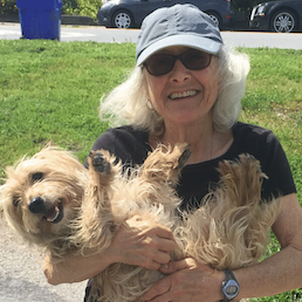 A close up photo of Jill Steinberg holding a dog