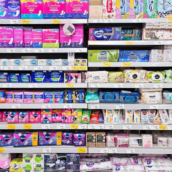 Packages of period products on a shelf at a store