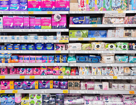 Packages of period products on a shelf at a store