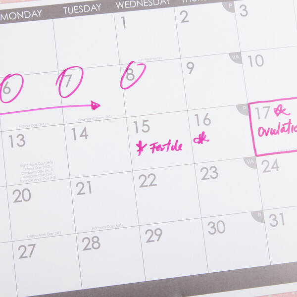 A calendar with ovulation and a fertile day marked on it