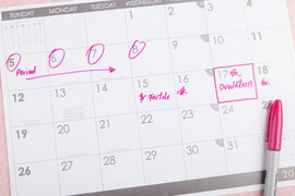 A calendar with ovulation and a fertile day marked on it