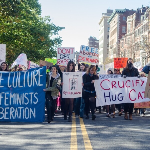 Women walk down the street in a protest against rape culture.