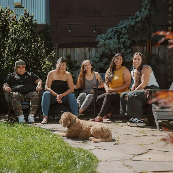 Five Indigenous doulas from Hummingbird Indigenous Family Services sitting outside