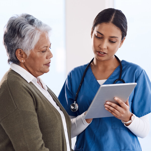A doctor explains medical results to an older woman