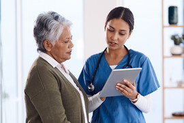 A doctor explains medical results to an older woman