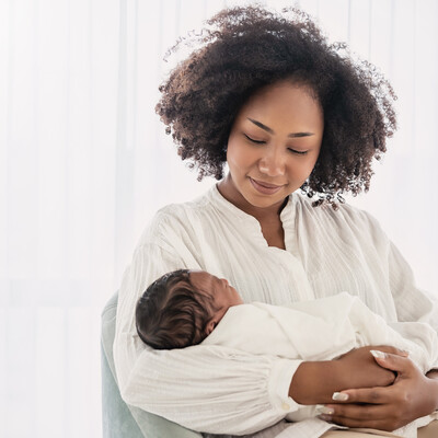 A Black mother holding a baby