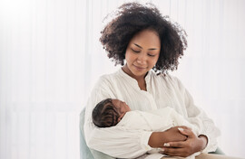 A Black mother holding a baby