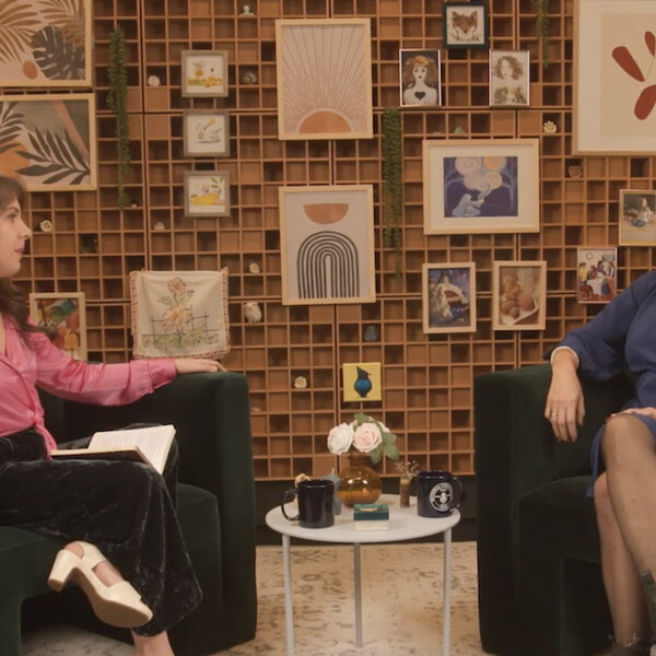 Two women sit together having a conversation