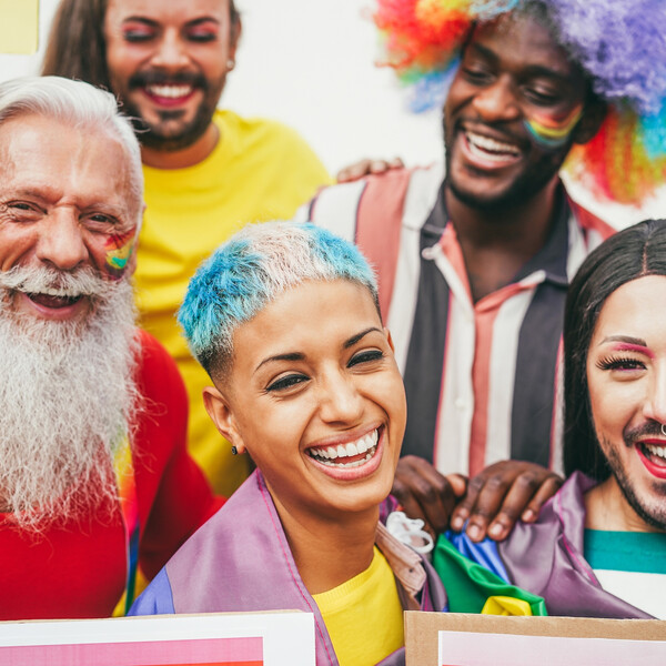 People of different ages, races, genders, and sexualities celebrate Pride