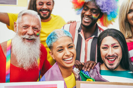 People of different ages, races, genders, and sexualities celebrate Pride