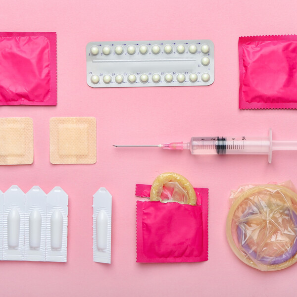 A pink background with different contraceptive methods