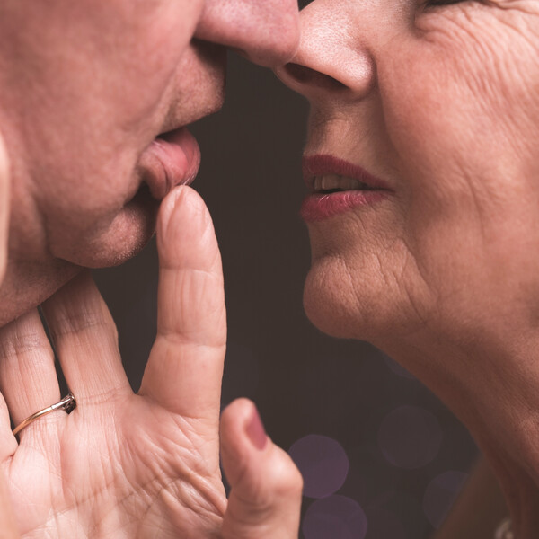An older white couple with their faces together