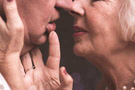 An older white couple with their faces together