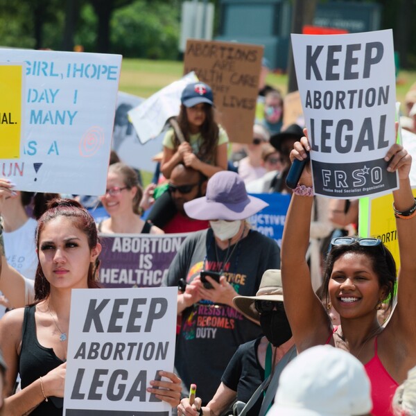 People standing at a protest on the Minnesota Capitol protesting for abortion access