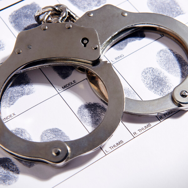 handcuffs laying on fingerprints chart