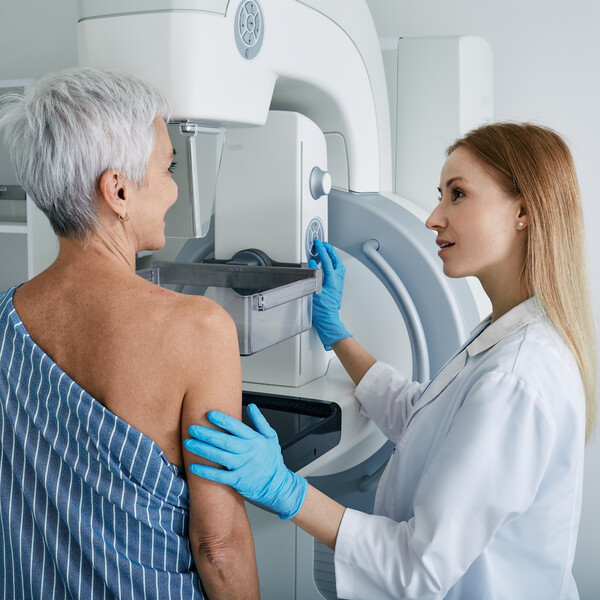 An older woman getting a mammogram
