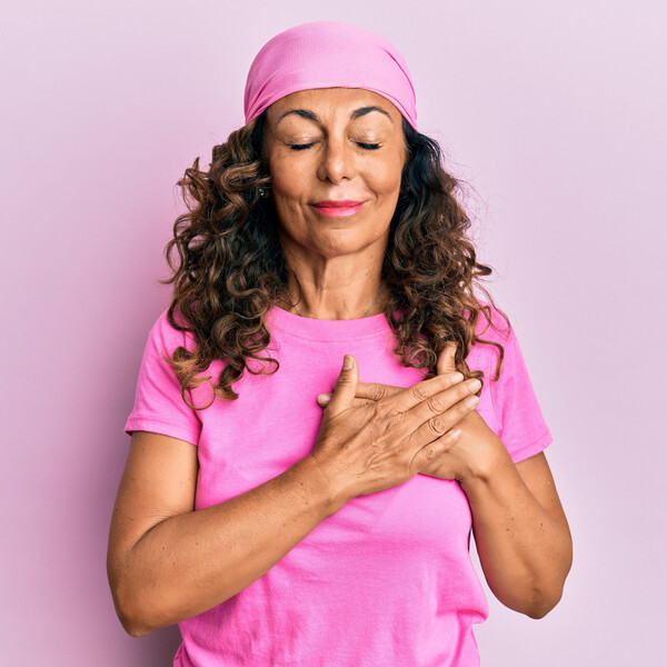 A woman in a pink t-shirt and pink scarf