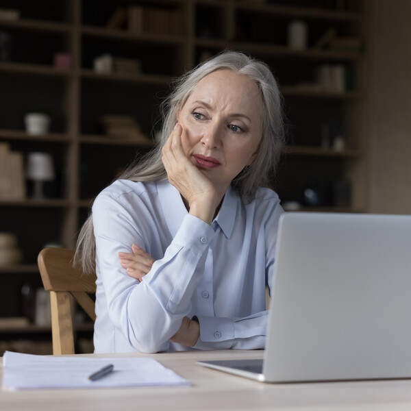 Older woman on computer with concerned look on her face