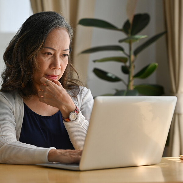 Older Asian woman on a laptop