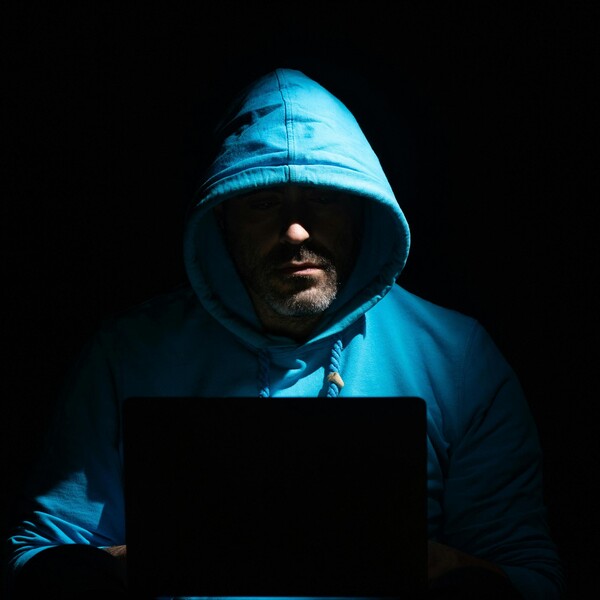 Man on computer in dark room