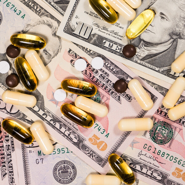 Pills on top of ten and fifty dollar bills