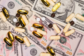 Pills on top of ten and fifty dollar bills