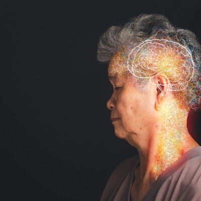 A profile of an older Asian woman with a white brain drawn on her head and colors around it