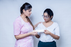 A mother gives a menstrual paid to her daughter