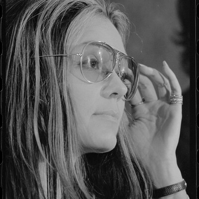 portrait photograph of Gloria Steinem wearing glasses, facing right.