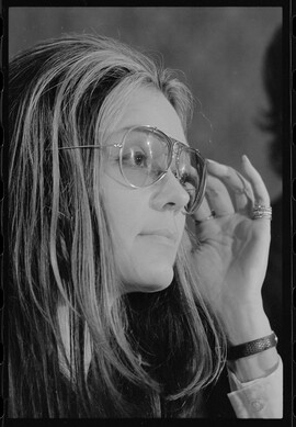 portrait photograph of Gloria Steinem wearing glasses, facing right.