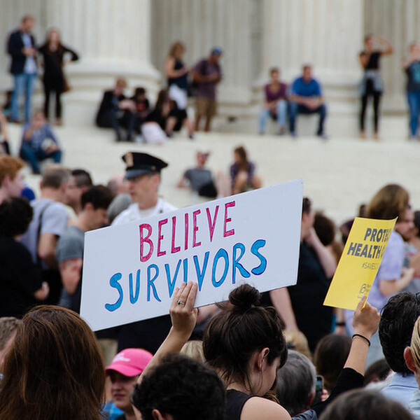 protest with believe survivors sign
