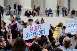 protest with believe survivors sign