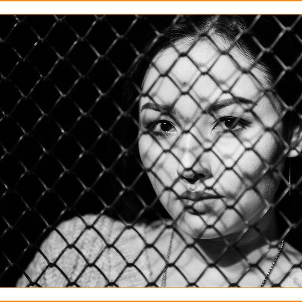 asian-woman-behind-gate