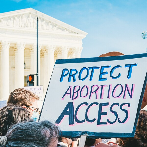 Protest in Washington, D.C. in support of abortion rights. Close up on a protest sign. A blue trimmed sign says "Protect Abortion Access”.