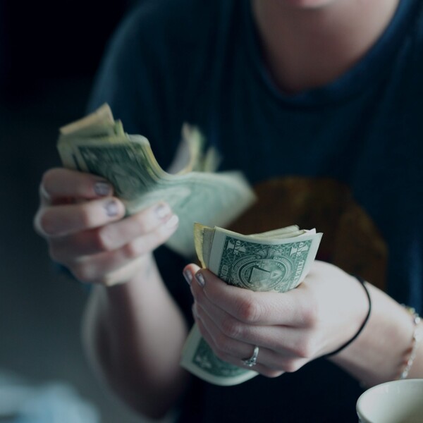 Sharon mccutcheon woman countying money unsplash scaled jpg