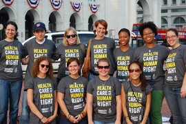 Group of people posing for a photograph, everyone is wearing a shirt that says "Health Care is a Human Right."